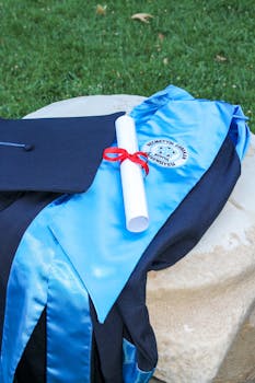 pexels photo 12752024 12752024 3 Blue graduation gown and hat with a diploma on a stone outdoors, symbolizing achievement.