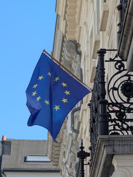pexels photo 31599496 31599496 EU flag displayed on a classic building in Antwerp, showcasing European identity.