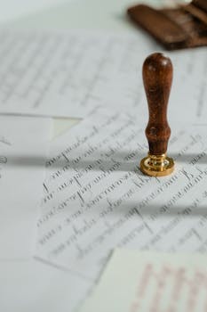 pexels photo 7333505 7333505 Vintage calligraphy papers with a wooden wax seal stamp, embodying timeless elegance.